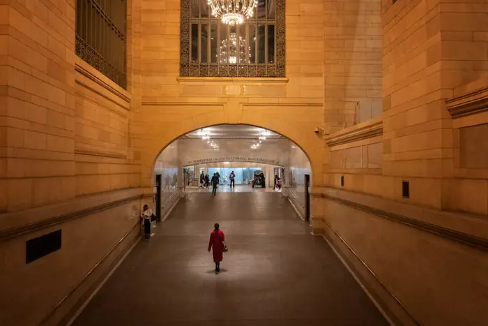 A person walks through a nearly empty corridor inside Grand Central Terminal.